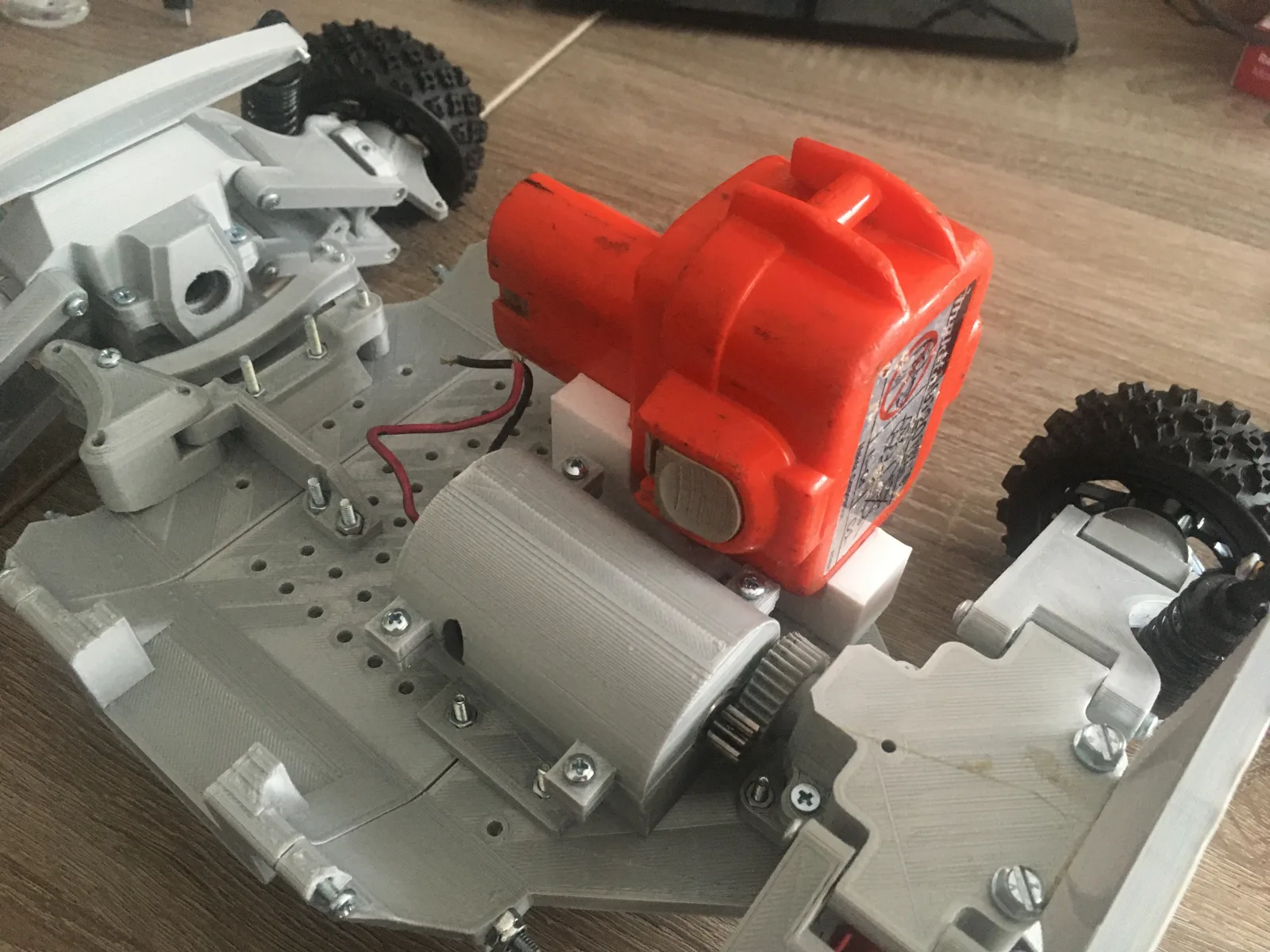 Drill motor mounted to the 3D-printed chassis after a drivetrain failure
